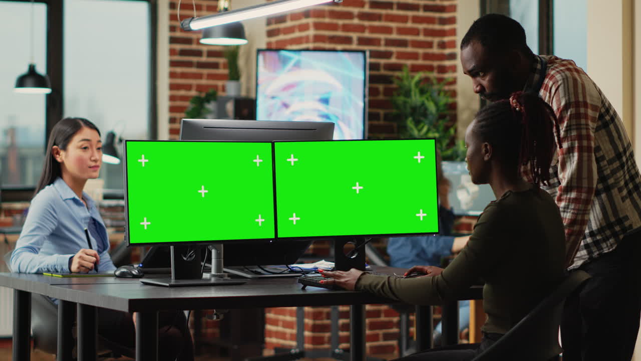 African american workers using greenscreen display on monitors