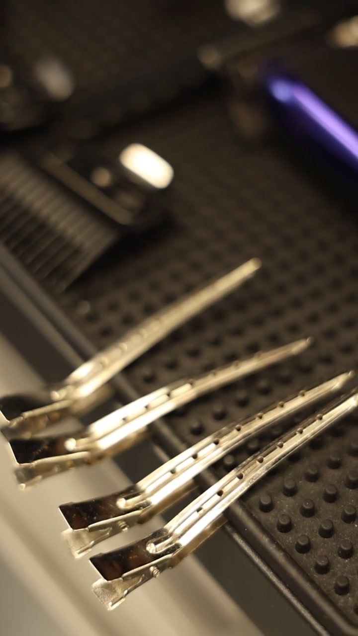 Metal Hair Clips Arranged on a Barber Station Mat