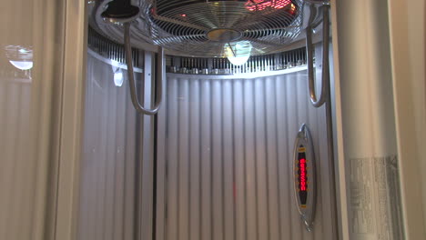 Static-shot-inside-a-silver-stand-in-tanning-sun-booth-with-LED-display