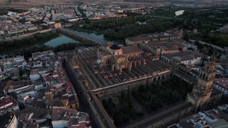 backward aerial view of mosque-cathedral and guadalquivir river in cordoba,spain