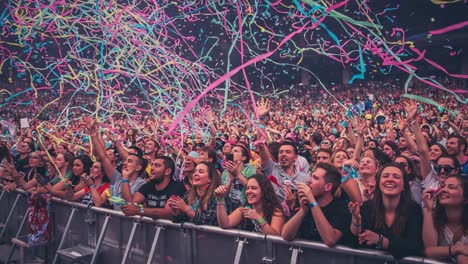vibrant celebration at a live concert: enthusiastic crowd engaged in joyful moments surrounded by colorful confetti and festive atmosphere
