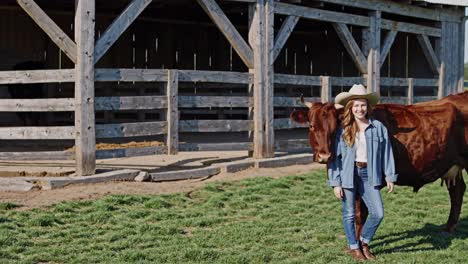woman with cow in a barn