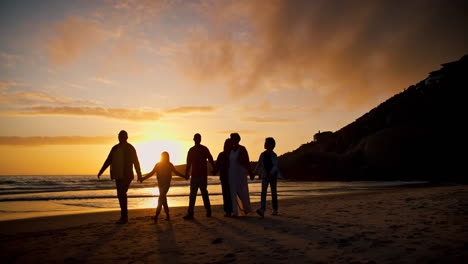 Sunset,-walking-and-shadow-of-people-at-the-beach