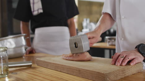 Diverse-group-of-chefs-preparing-dishes-and-smiling