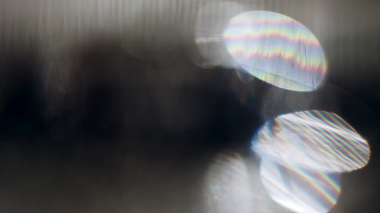 Close up of a clear glass of water on a table, with soft reflections and light refractions