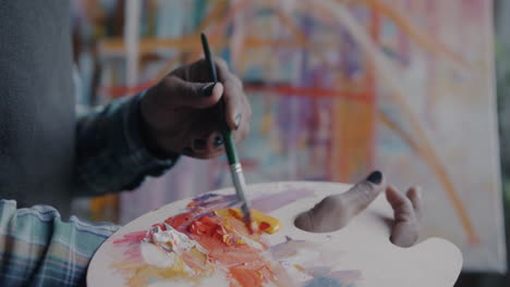 artist painting with palette knife