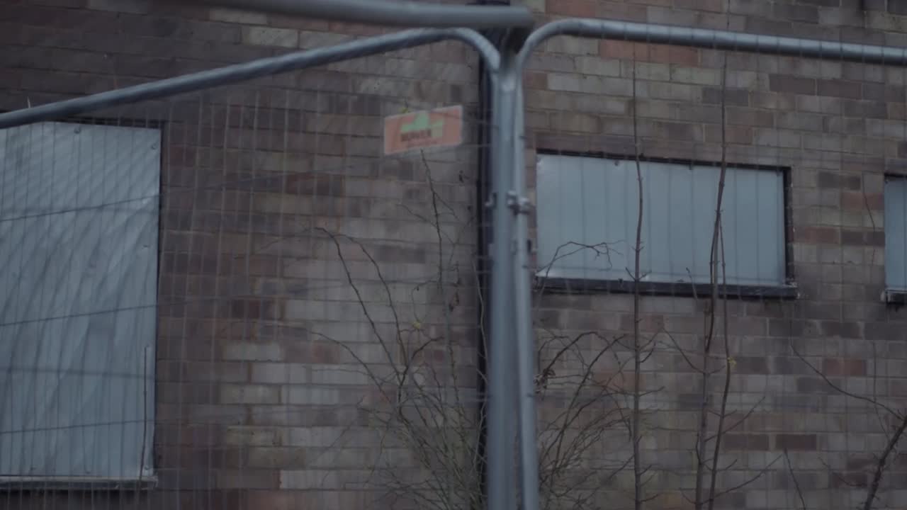 Dangerous building after fire surrounded by fencing