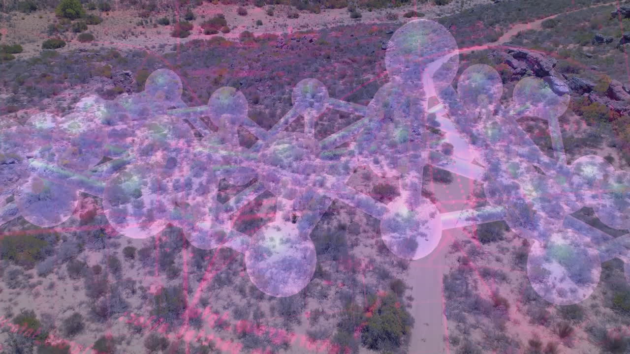 3D network of translucent spheres linking through thin rods hovering over desert with pink grid