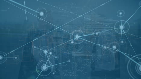 animation of connected dots, globes and computer language against aerial view of modern cityscape