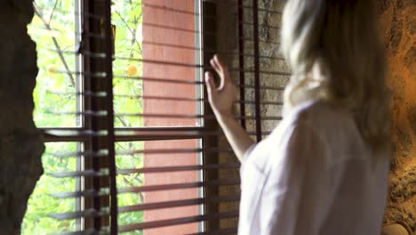 woman looking out a window