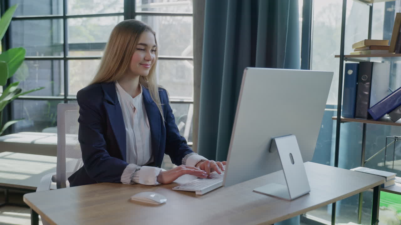 Young woman working on computer in a modern office