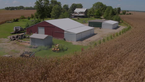 aerial of a family farm with farmland a barn and a farmhouse in view