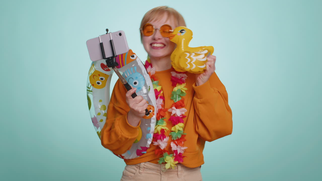 Traveler blogger tourist woman in sunglasses taking selfie on smartphone record make video call