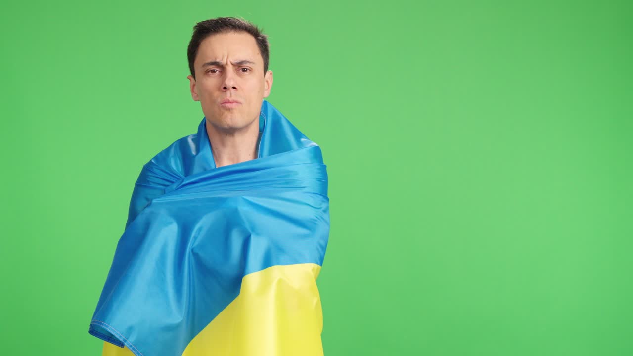 Man wrapped in a Ukrainian flag with pride and dignity