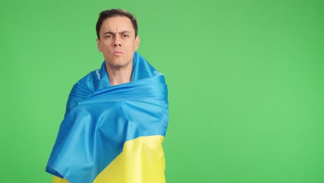 man wrapped in a ukrainian flag with pride and dignity