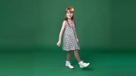 cute little ginger girl dancing and fooling around