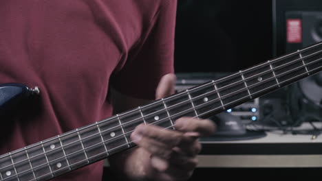 Musician-plays-bass-guitar,-close-up-on-the-bass-neck-4K