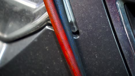 car engine compartment with various pipes and hoses