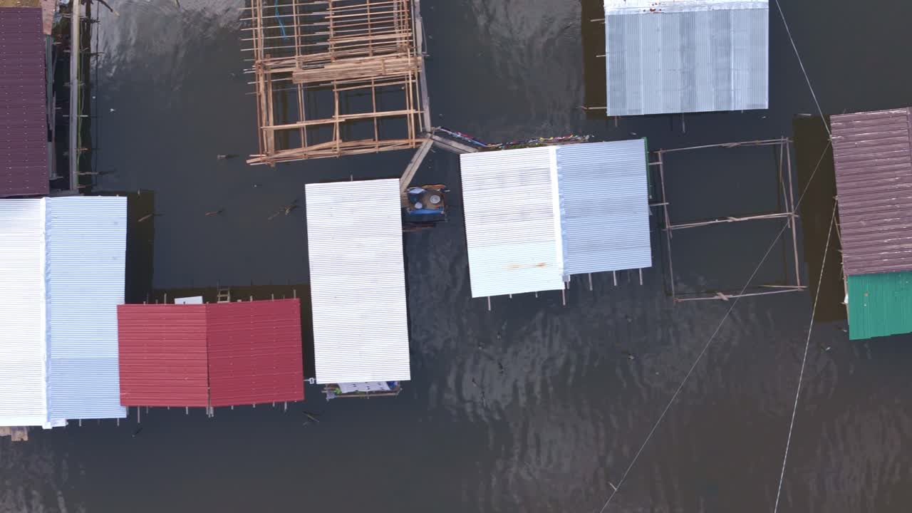 Drone top down pan over a squatter area in Surigao City, with narrow pathways and crowded housing, highlighting local housing challenges and resilience