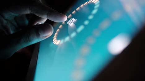 man's hand working on digital tablet on office desk