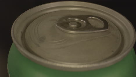 close macro view of top of metal soda can spinning