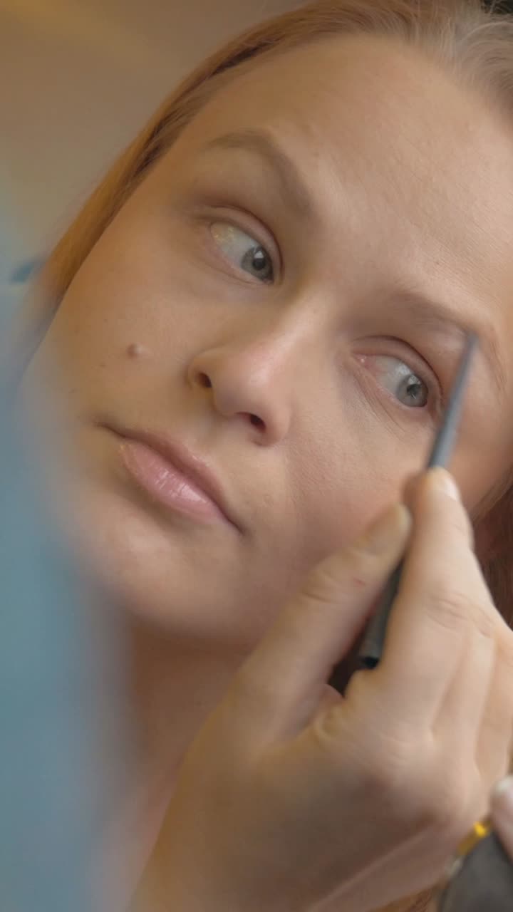 Woman applying makeup