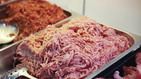 close-up of a tray of minced ground meat in a butcher shop window