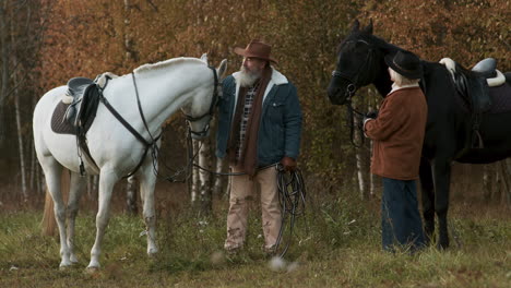 mature couple with their horses