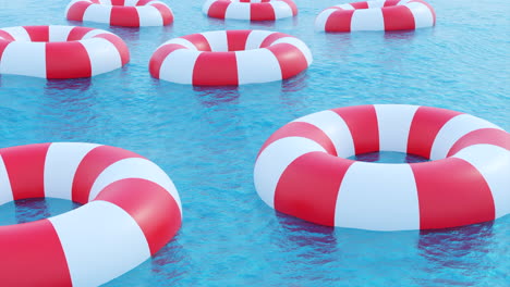 red and white life preservers floating on water