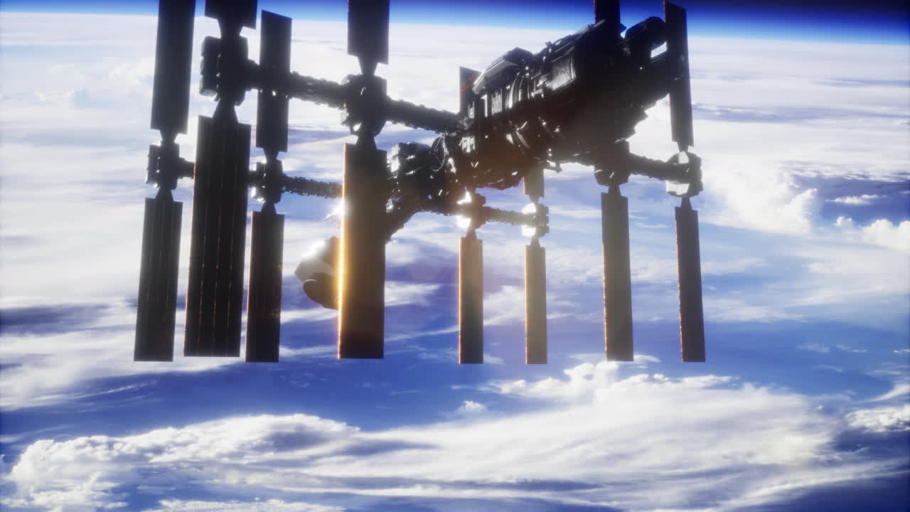 International space station orbits earth at sunset with glowing clouds