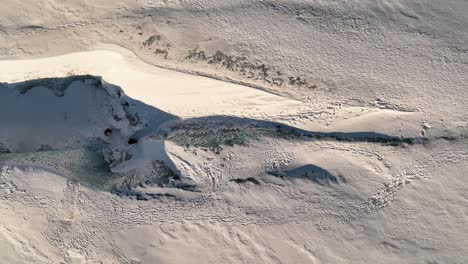 aerial top view over people hiking on sólheimajökull glacier, in iceland, at dusk