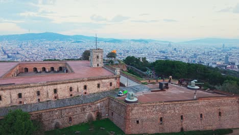 montjuic castle on the hill above barcelona, aerial push in