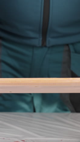 applying finish to a wooden plank