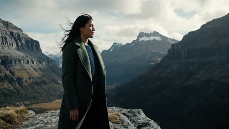 woman in a coat in a mountain landscape