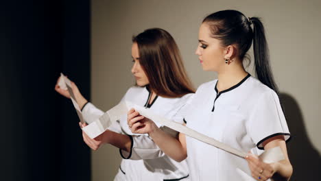 two women doctors examine a printout from an electrocardiogram. medical discussion