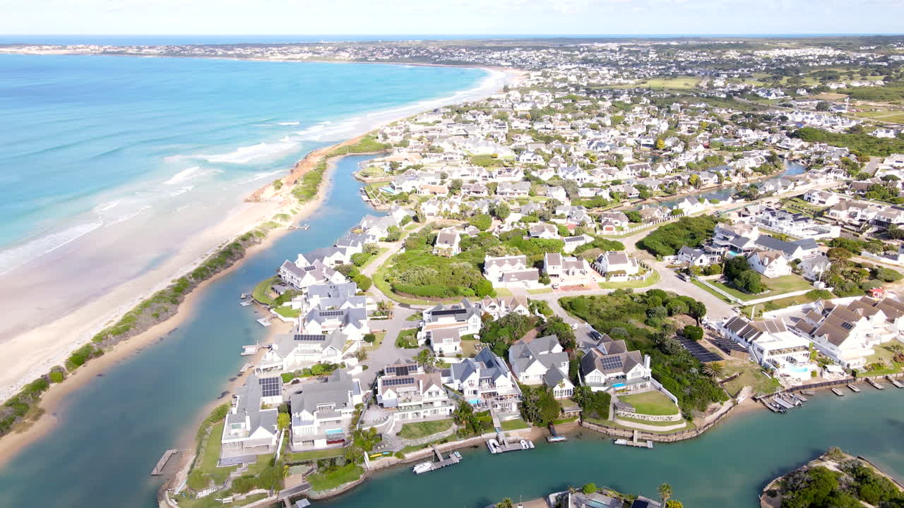 Affluent residential neighborhood of St Francis Bay on canals, aerial tilt-up