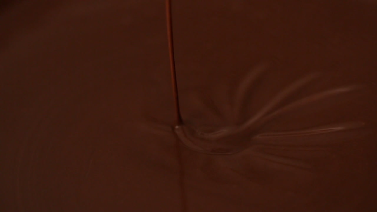 Whisk moving in melted chocolate
