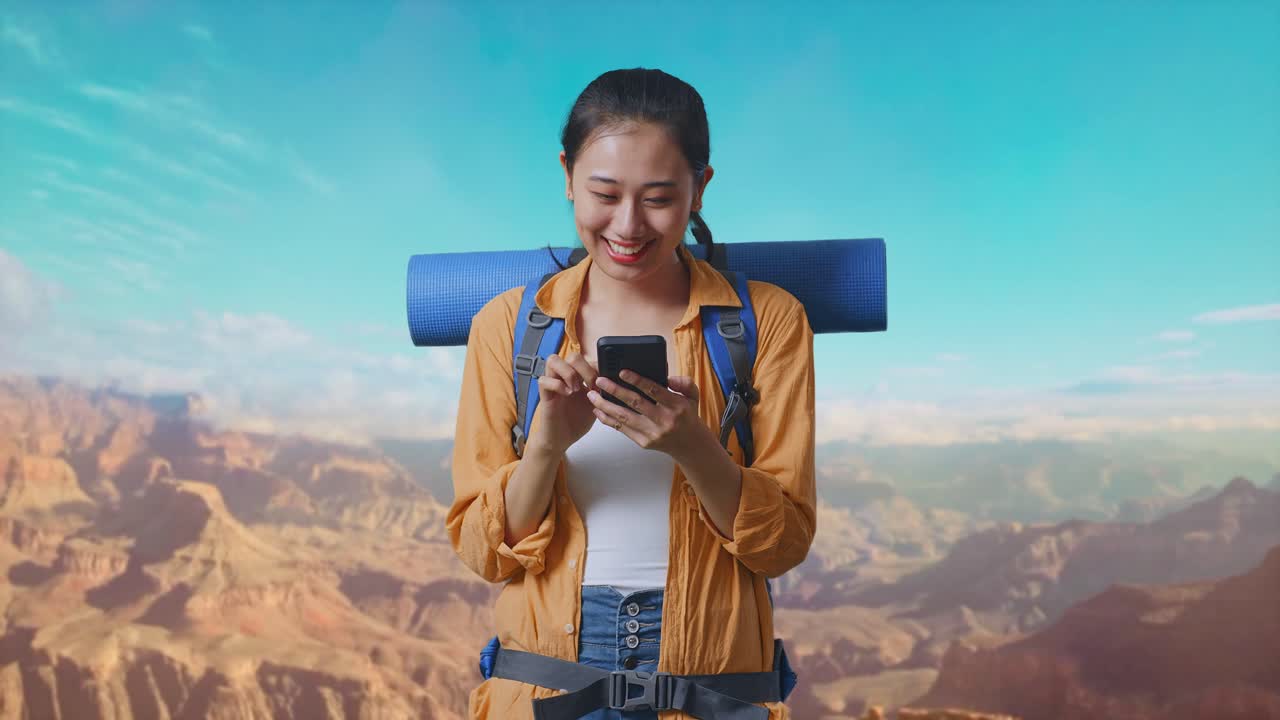 Asian Female Hiker With Mountaineering Backpack Enjoy Using Smartphone While Traveling At The Top Of Mountain