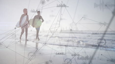 Couple walking along shoreline at sunrise, carrying surfboards, showing technology data charts