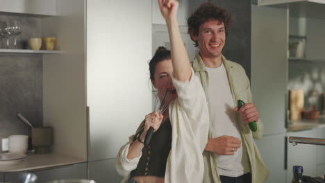 playful couple cooking and having fun in the kitchen