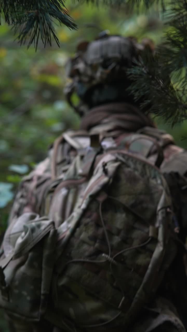 Soldato in uniforme mimetica in una foresta