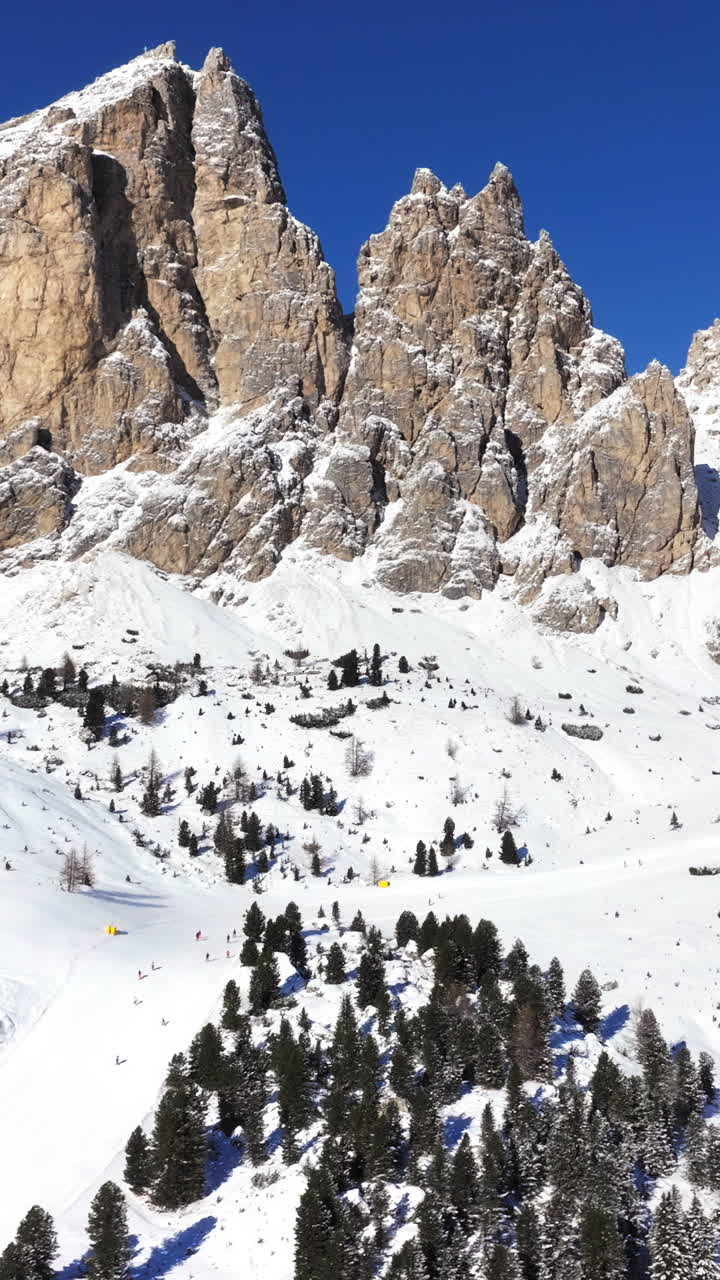 Aerial drone view of the Gardena Pass high mountain pass in the Dolomites, Italy. Vertical