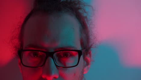 man with glasses, eyes intense, behind each lens, his thoughts immense