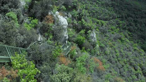 Adventurous-hike-along-the-Nago-Torbole-Busatte-Trail-near-Lake-Garda,-Italy,-amidst-dramatic-skies-and-rocky-terrain