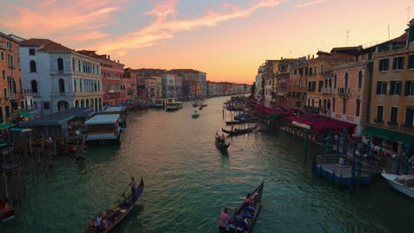 grand canal, canale grande in venice, italy by sunset with boats and gondola, old houses and a cathedral close to san marco and rialto bridge