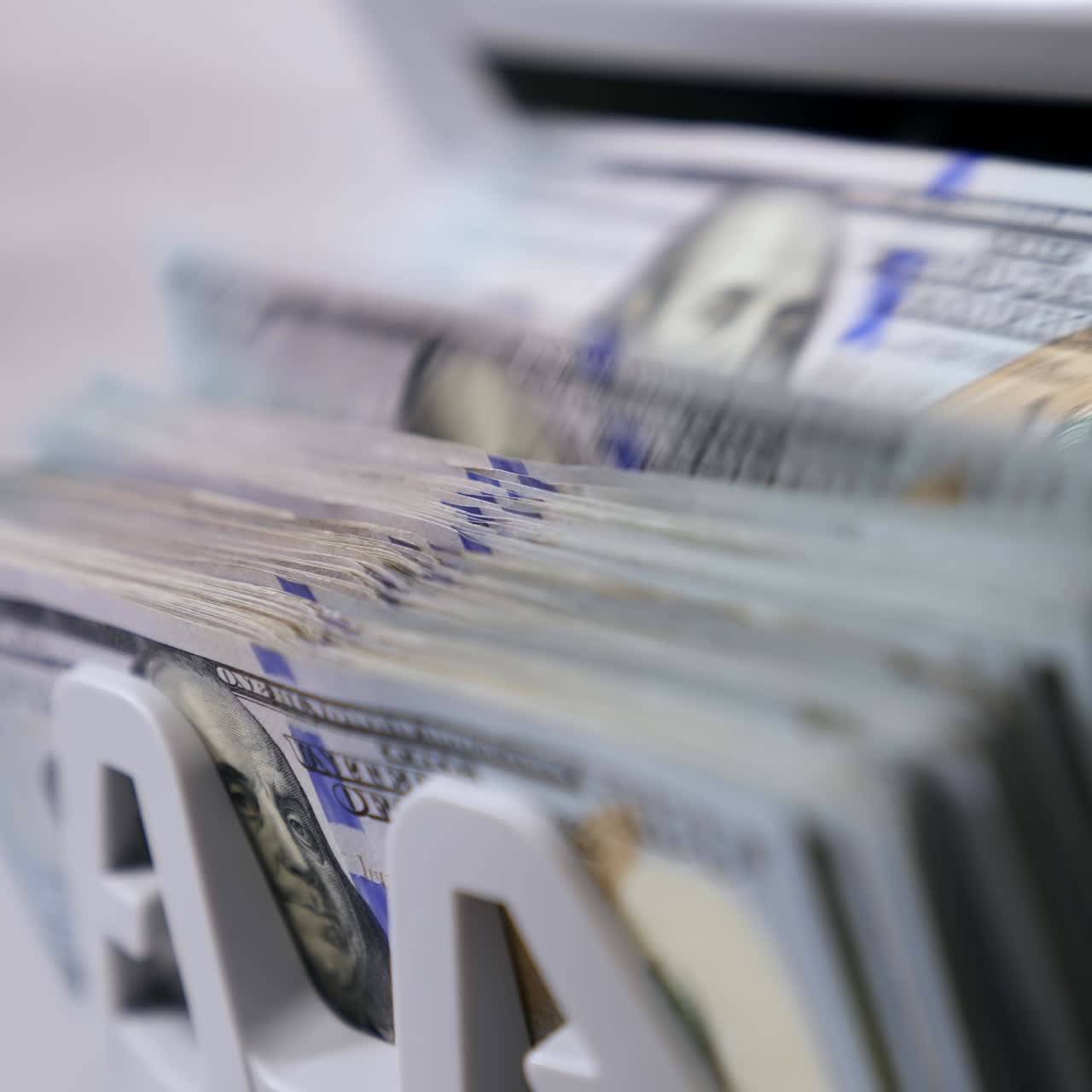 Money counting machine. Banknote counter are counting hundred dollar bills. Close-up