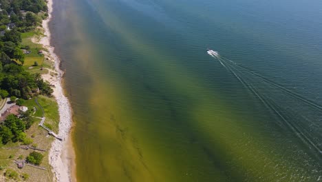 A-boat-sails-along-the-coast-in-early-Summer-of-2020