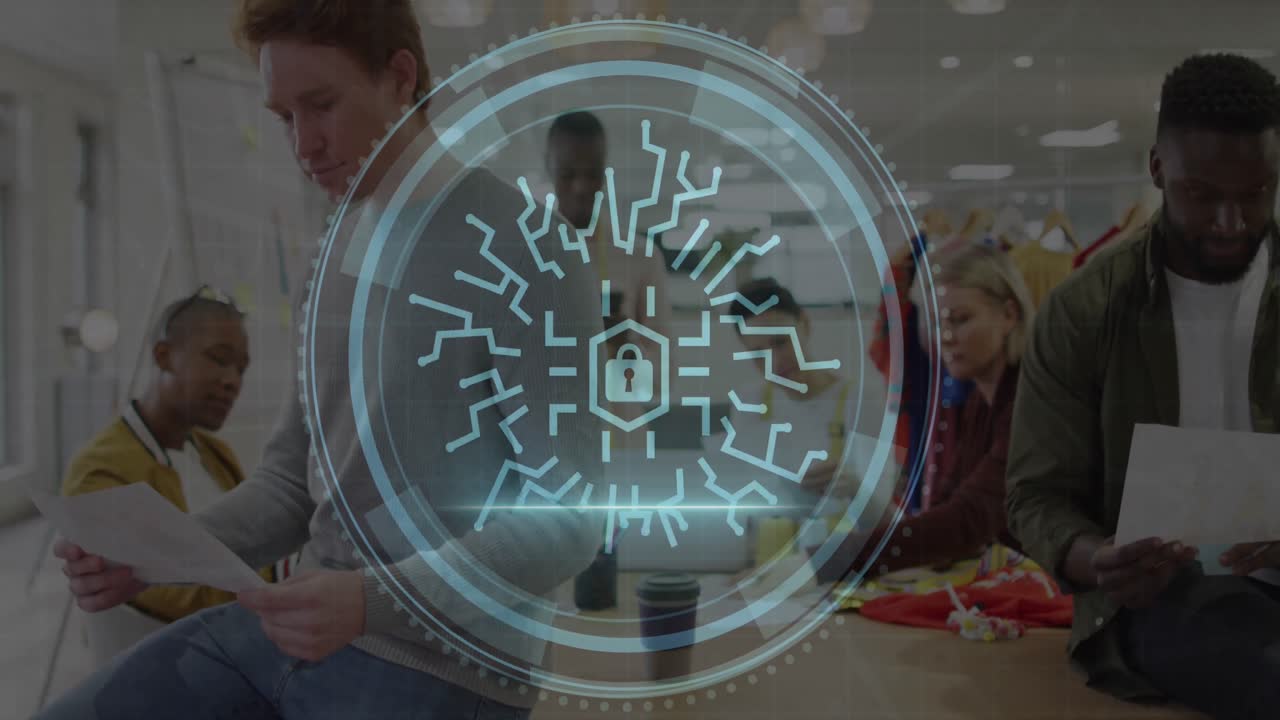 Animation of cyber security text and lock icon over diverse fashion designers working in studio