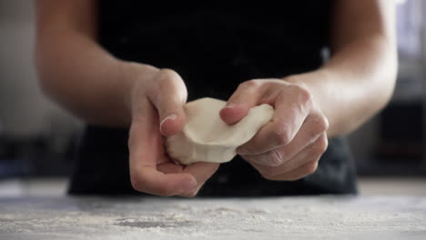 an-unrecognizable-woman-kneading-dough-at-home