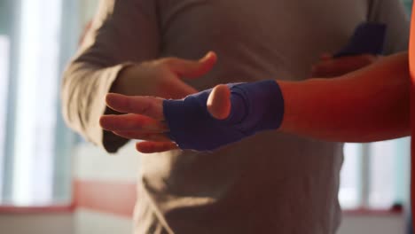 Close-up-view-of-Caucasian-man-wrapping-another-man-hands